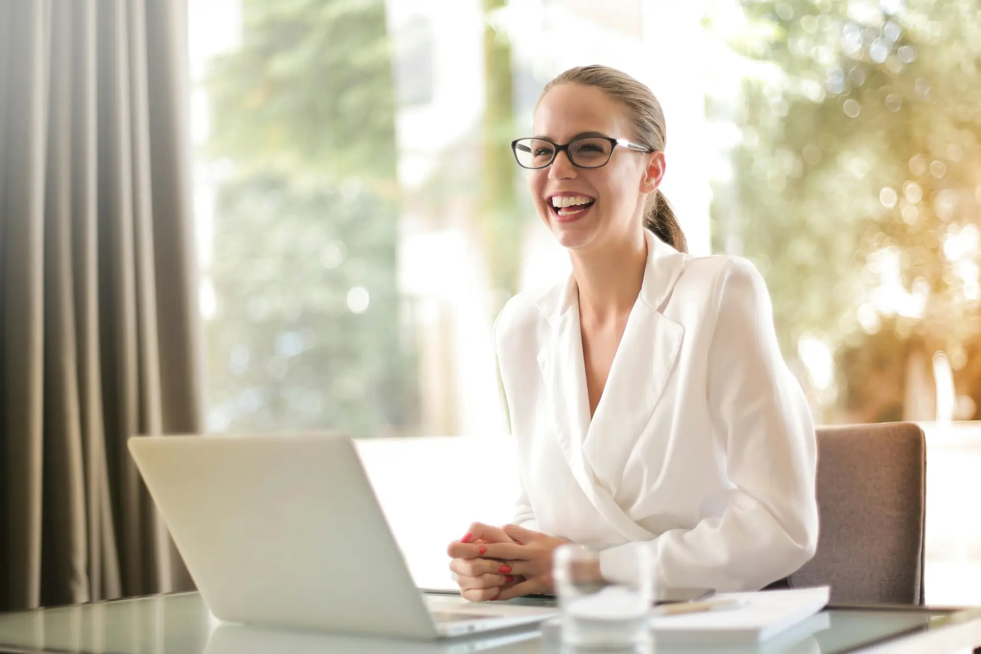 Woman smiling while using laptop